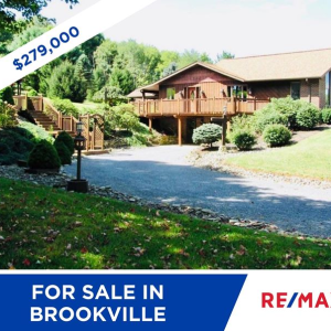 BACK ON THE MARKET IN BROOKVILLE FOR $279,000! Stunning move-in ready 3 bed, 2.5 bath ranch features granite countertops, an all-season room, fully finished basement, new furnace, and whole house generator. The exterior is finished in brick & cedar, a photo