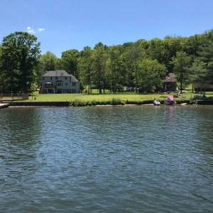 NEW WATERFRONT LOT AVAILABLE ON TREASURE LAKE FOR $159,900! Level lot is perfect for building your dream lake house with community water, sewer, electric, and natural gas available. Ideally located to the back gate, and walking distance to New Providen photo