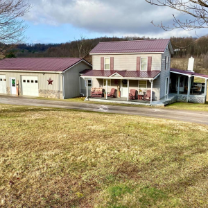PRICE REDUCED IN SUMMERVILLE TO $289,000! This 3 bed, 1.75 bath farmhouse has it all! Situated on 49+ acres, it features FREE gas, a cozy family room & stone fireplace overlooking a stream behind the house, central air, 3 car attached garage, 2 car d photo